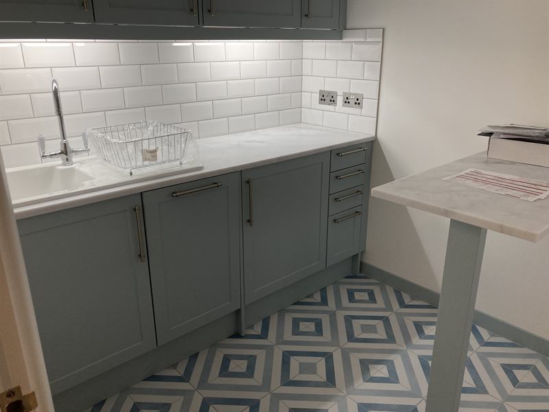 Finished kitchen with grey units and metro tile splashback
