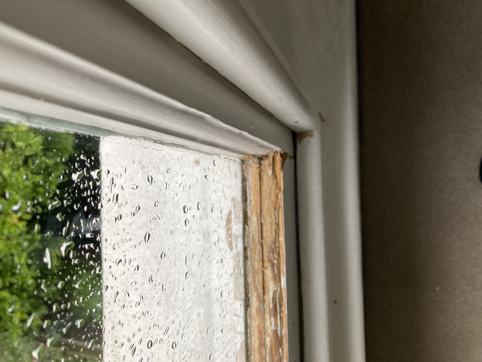 Close-up of a weathered timber sash window frame in need of repair
