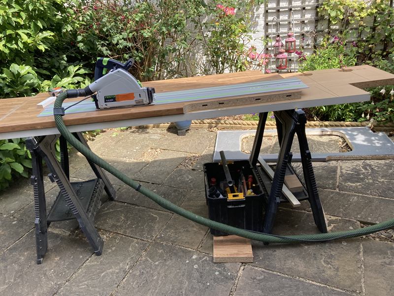 Track saw cutting a worktop on trestles